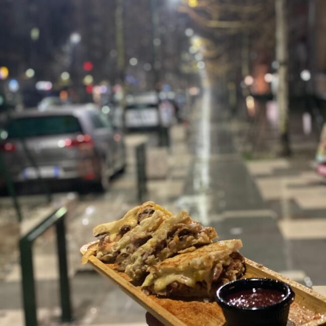 A man holding a skepasti outside the fast food restaurant in Vlore, Albania